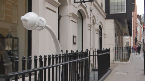 Fashion-Store-With-Bent-Metal-Lampost-Sculpture-Outside-In-Mayfair-London-UK